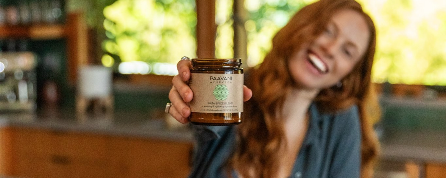 Woman holding PAAVANI Vata Spice Blend for Ayurvedic Digestion