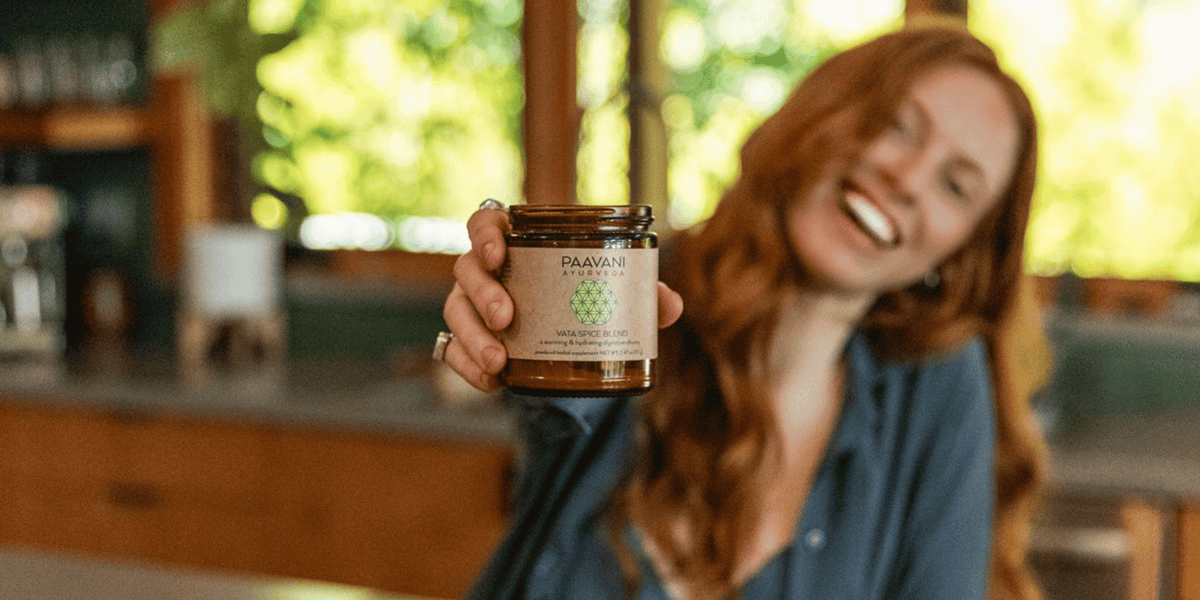Woman holding PAAVANI Vata Spice Blend for Ayurvedic Digestion