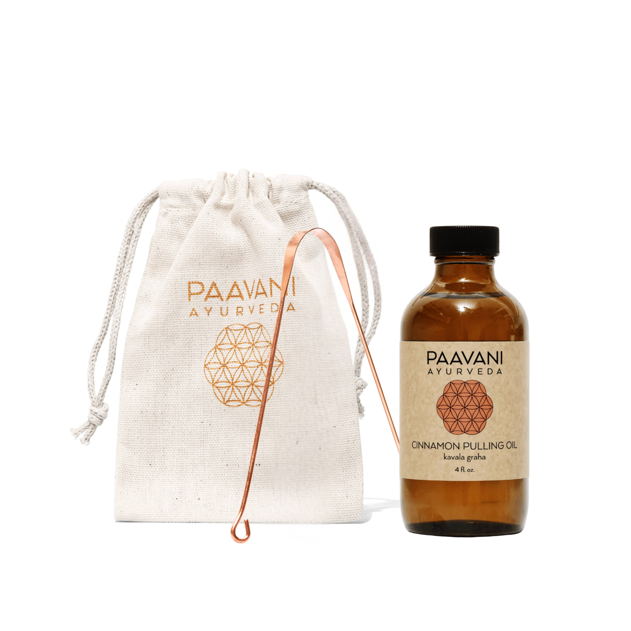 Paavani Ayurveda cinnamon pulling oil bottle with a copper tongue cleaner and drawstring bag. All part of the oral care ritual
