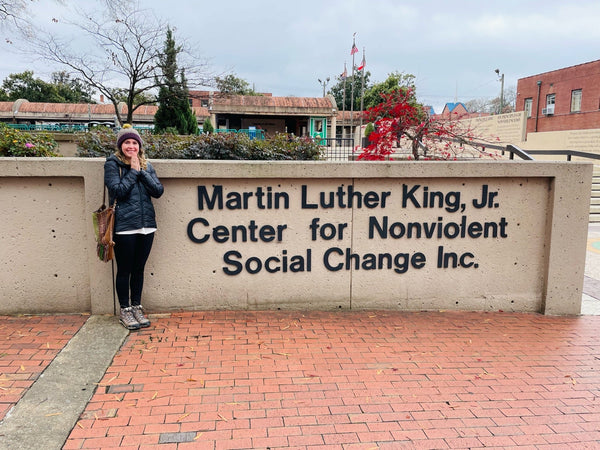 Woman standing in front of the Martin Luther King, Jr. Center for Nonviolent Social Change Inc.