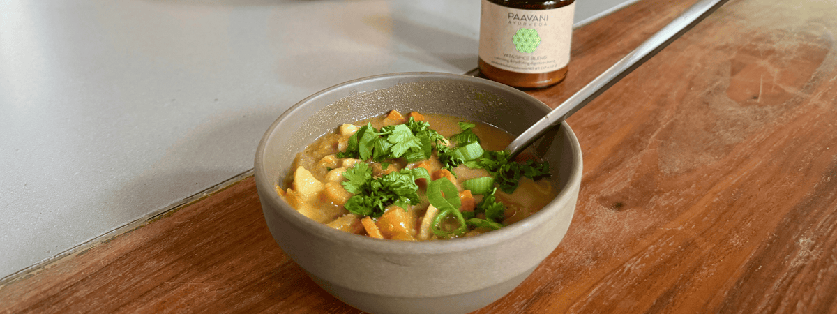 A bowl of homemade root vegetable miso soup with carrots, sweet potatoes, parsnips and butternut squash, seasoned with warming Ayurvedic spices.