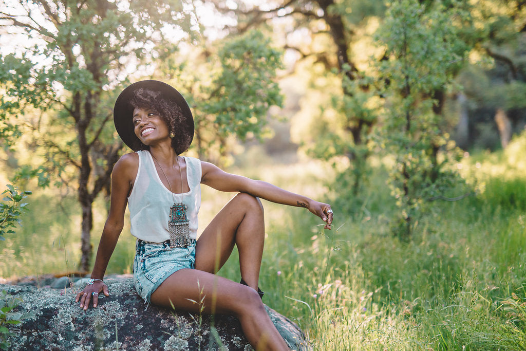 beautiful girl setting on a rock