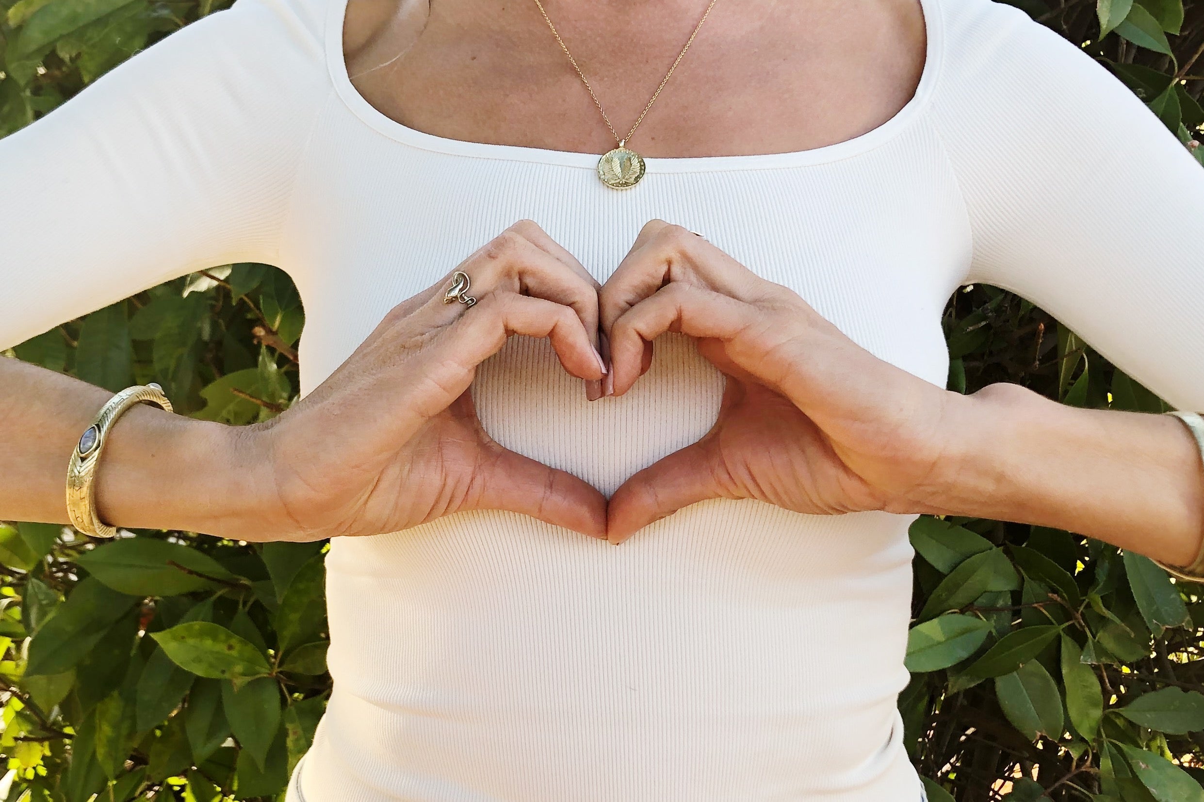 hands forming heart over chest