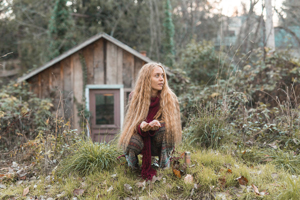 woman holding herbs outside during fall