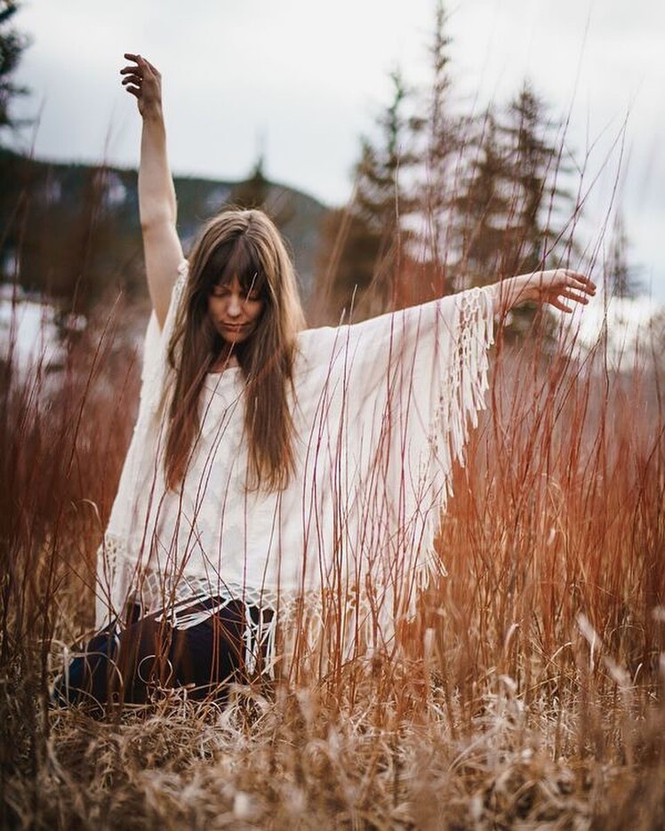 Woman flowing through yoga poses to harmonize masculine & feminine energy