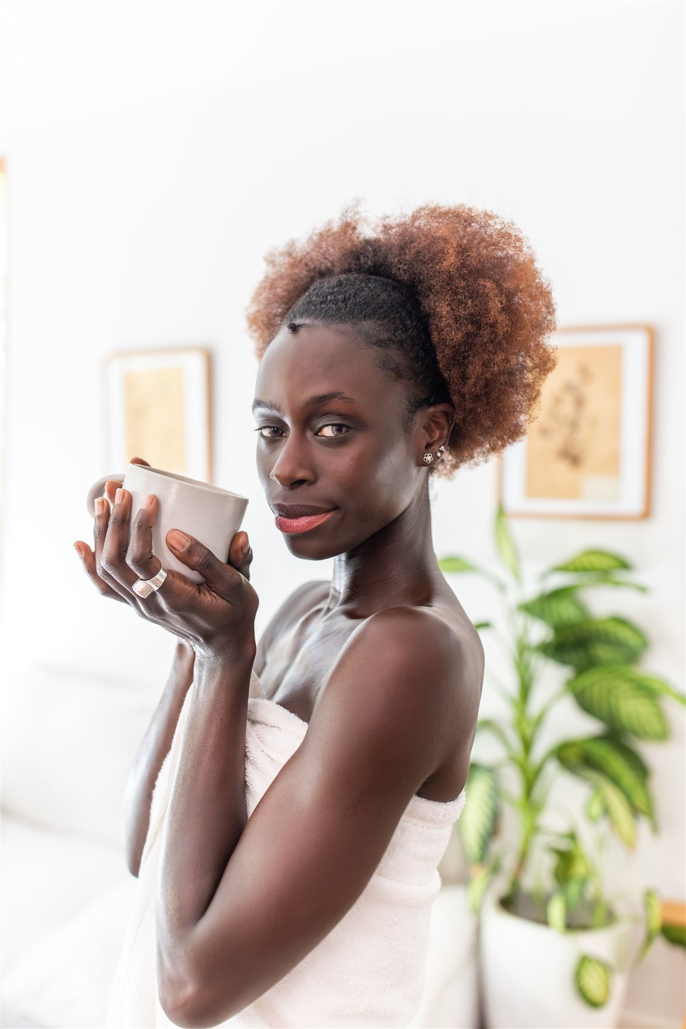 Beautiful woman drinking warm water for her Ayurvedic morning routine for clarity and confidence