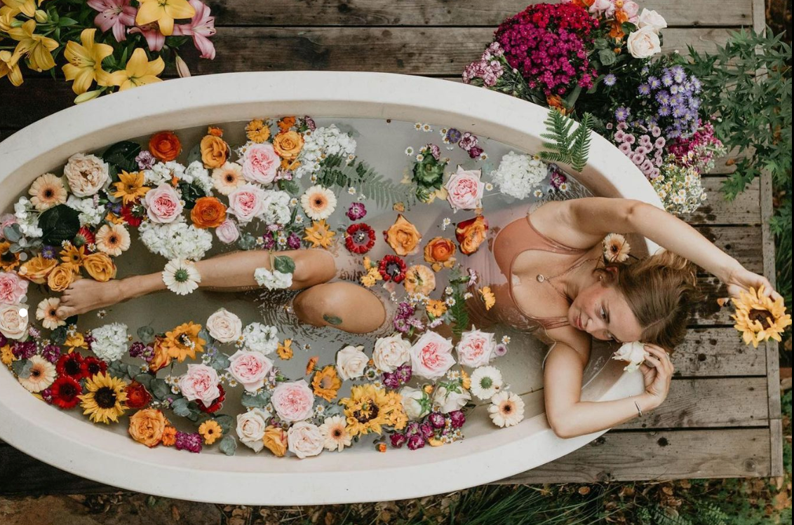 woman taking an outdoor bath with PAAVANI Coconut Milk Bath