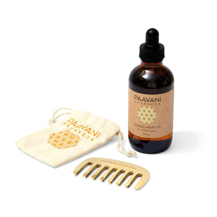 PAAVANI Ayurveda Herbal hair oil bottle with a dropper, kansa comb, and cloth storage pouch on a white background