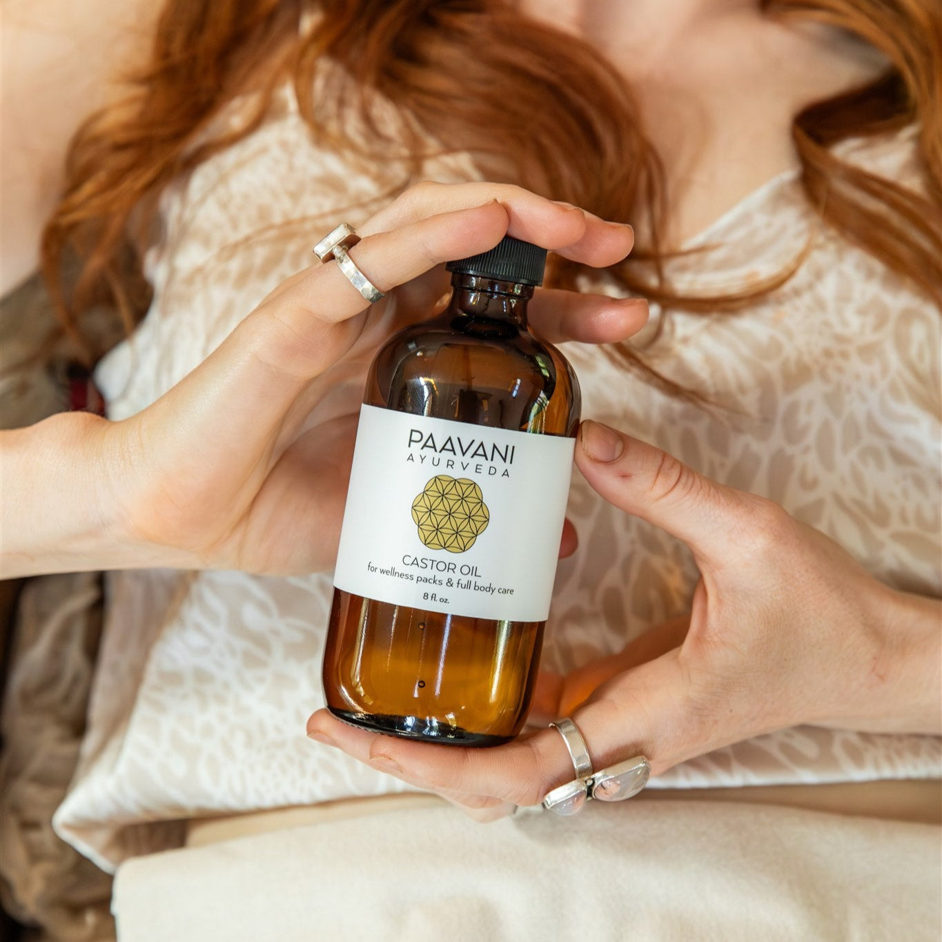 Person holding a bottle of Paavan Naturals product with a blurred background