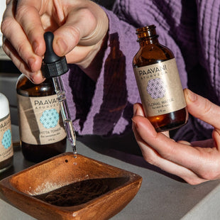 Person in a purple robe preparing their PAAVANI Cleanser & Mask ritual