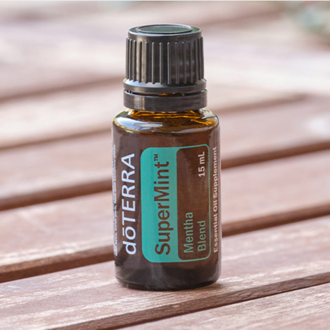 doTERRA SuperMint essential oil bottle on a wooden surface